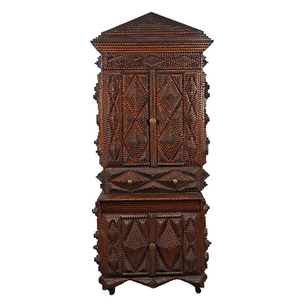 A 19th century carved wood Tramp Art cupboard.