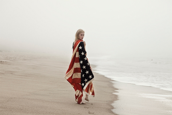 Girl on the beach with American Flag Cape photographed by Lauren Ward.