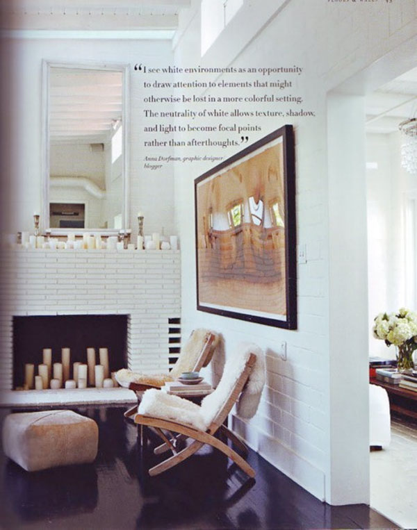 A chic white brick living room fireplace.