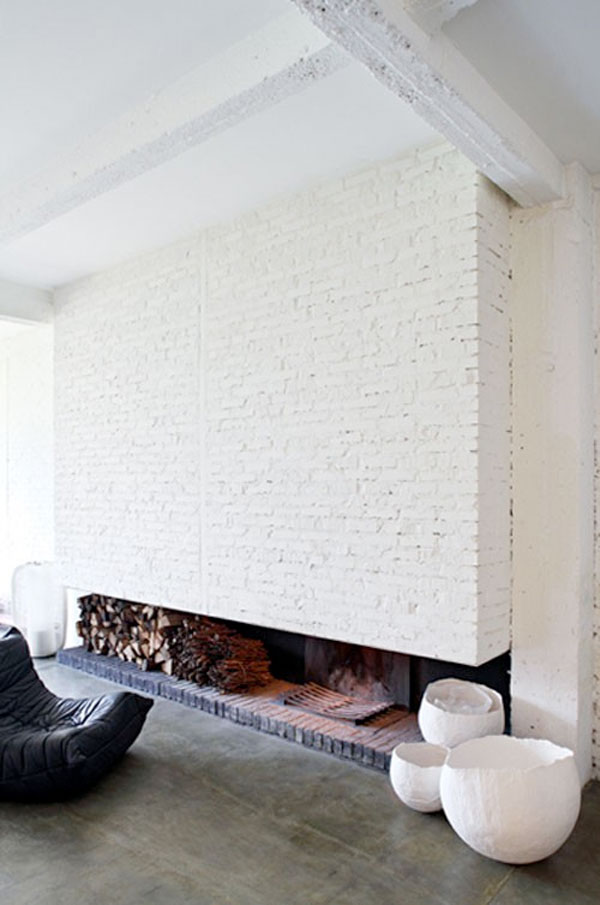 A minimal modern painted white brick fireplace.