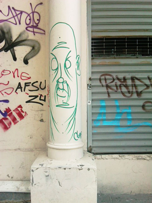 A graffiti detailed architectural column on a New York City cast iron building.