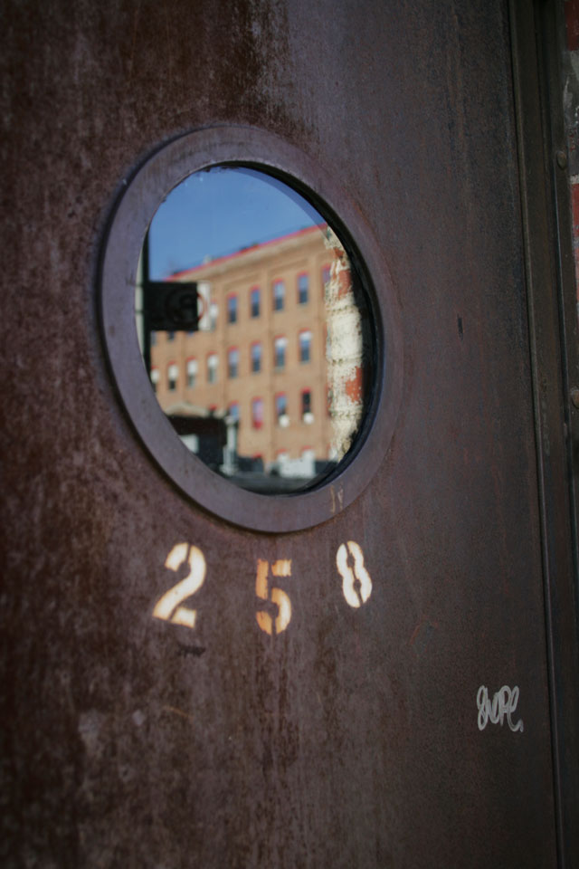 A rusty metal graffiti door in Williamsburg Brooklyn.