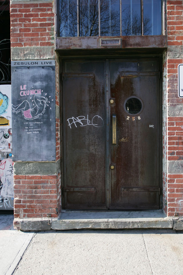 A rusty metal graffiti door in Williamsburg Brooklyn.