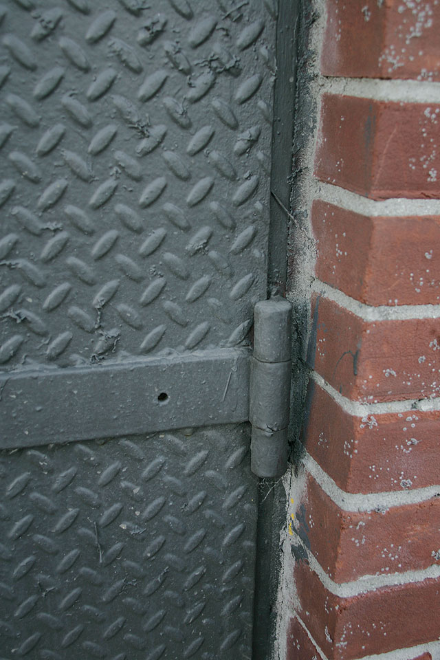 Grey painted steel doors with elongated modern hardware.