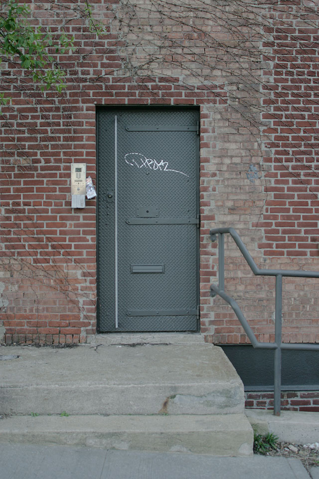 Grey painted steel doors with elongated modern hardware.