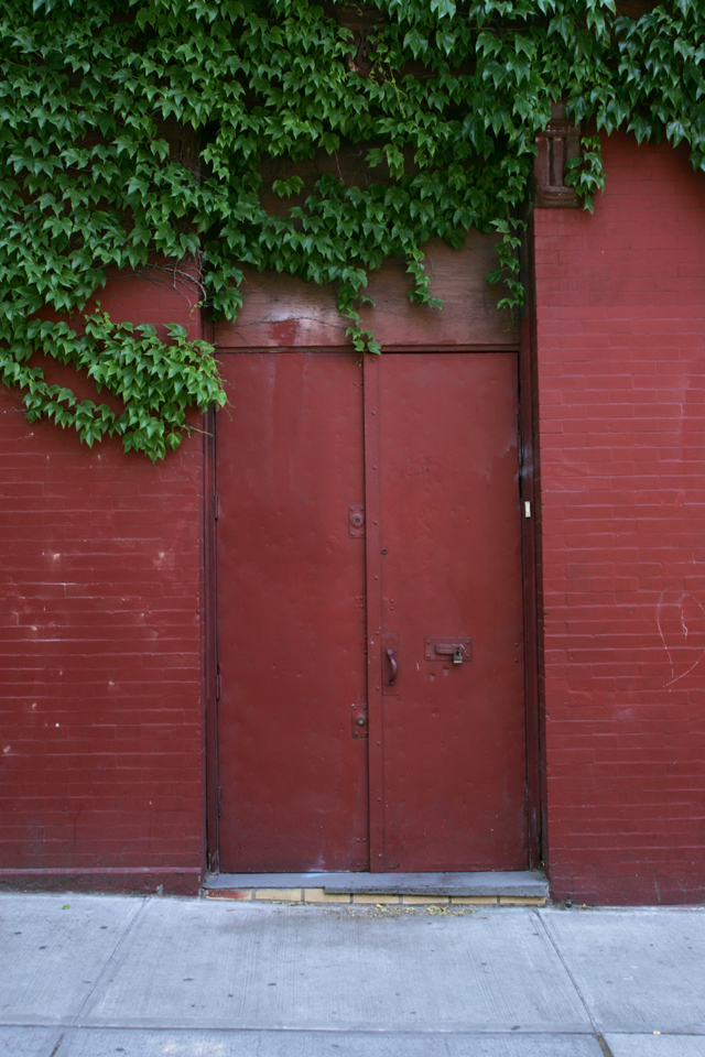 Painted red industrial door in Williamsburg Brooklyn.