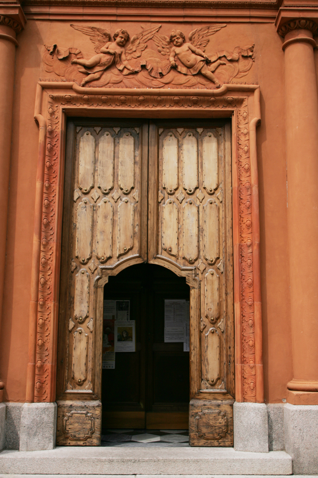 Antique wood church door in Como, Italy.
