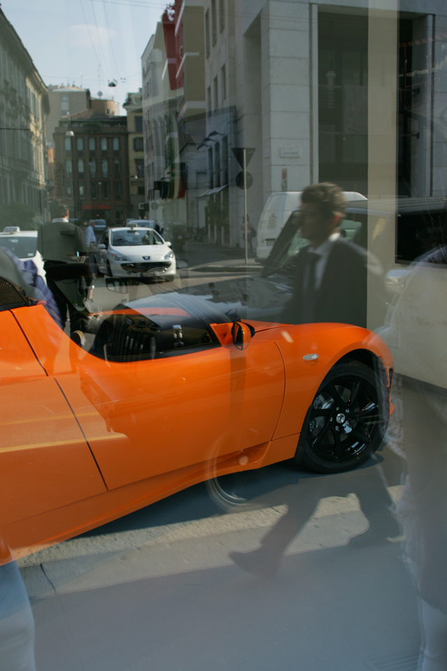 Neon orange sports car in Milan Italy.