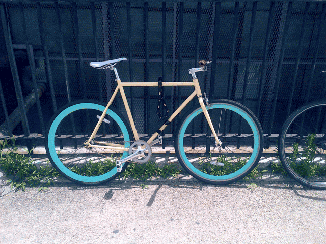 Retro yellow and blue pastel colored bicycle.