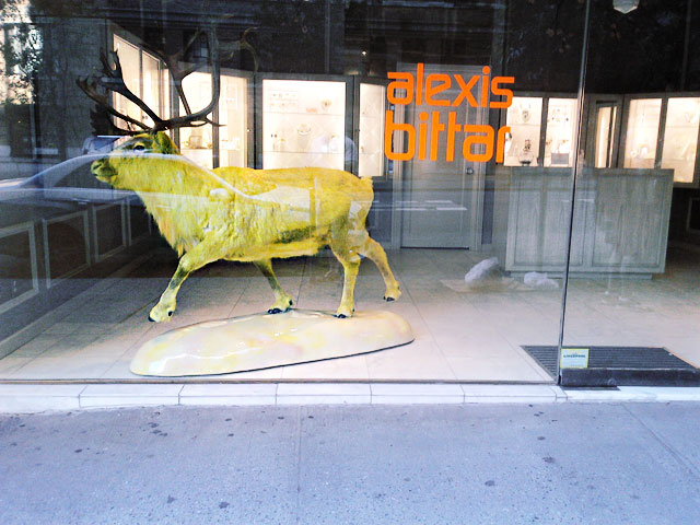 A neon yellow moose at the Madison Avenue, NYC Alexis Bittar window. 